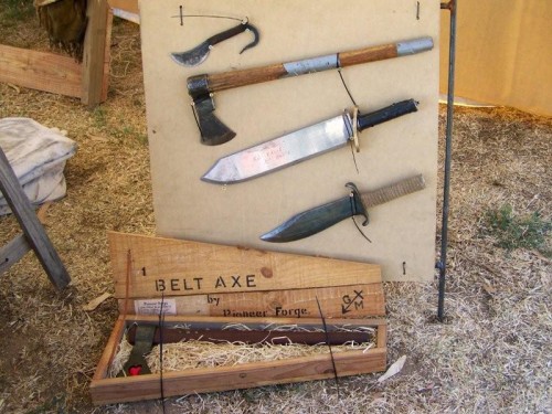 A cased belt axe and other useful alternate farming tools.